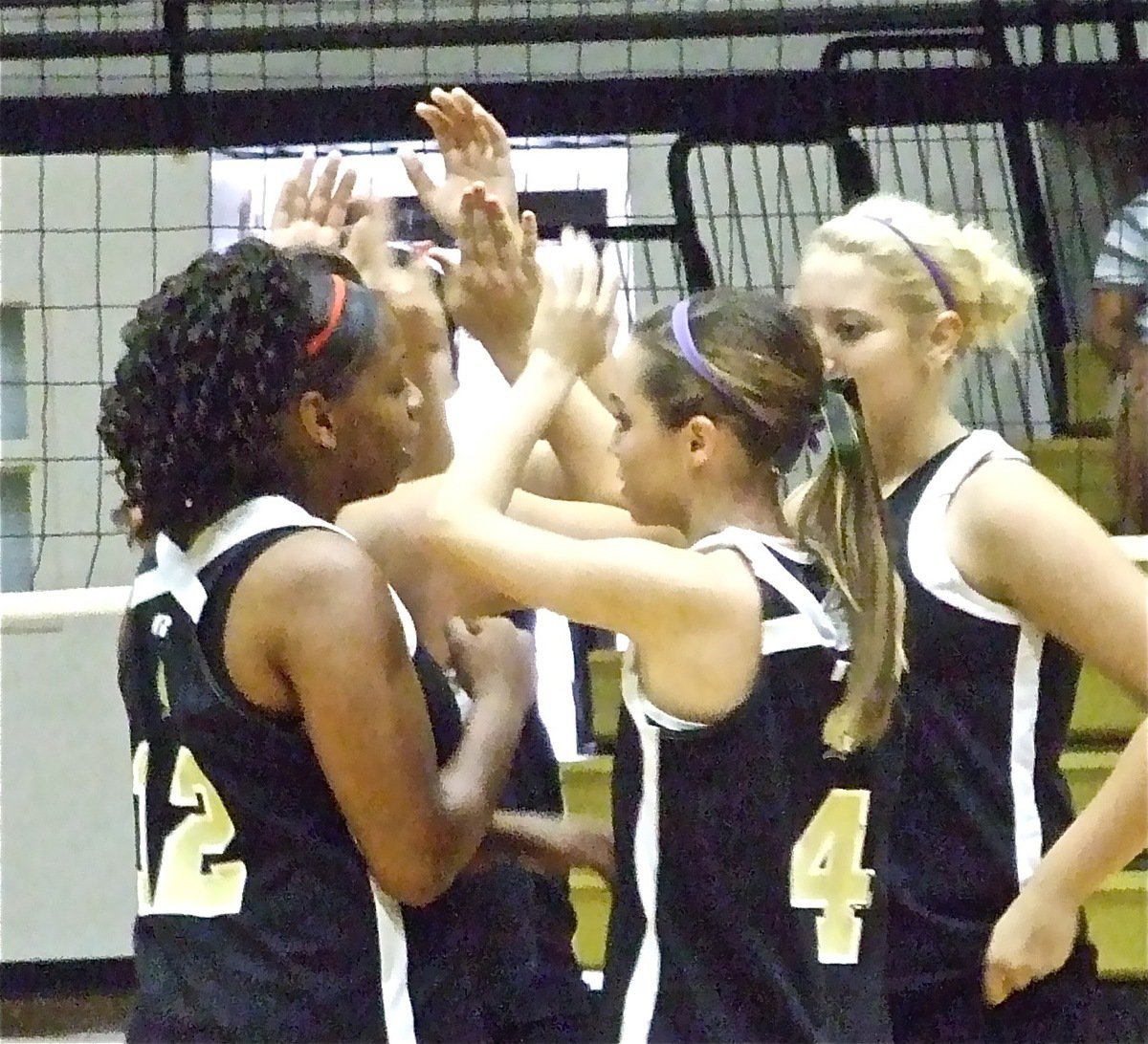 Image: Taking momentum — The Lady Gladiators huddle after a point against the Lady Bulldogs in an effort to turn the rare point into a late rally.