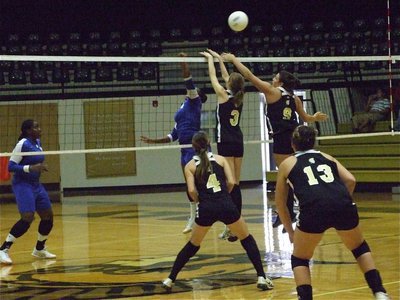 Image: Rossa and Jeffords — Kaitlyn Rossa (3) and Cori Jeffords (9) attempt a block against Milford.