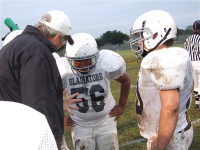Image: Five things to remember — Coach Coleman advises his linebackers, Darol Mayberry(56) and Zain Byers.