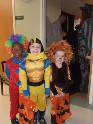 Image: Clown, Robot and Lion — These little ones were having fun collecting candy from the residents.