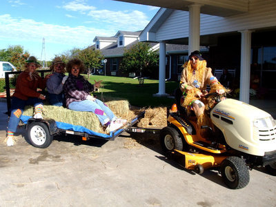 Image: Scare Crows — Marie Wood, Debbie Knott, Debbie Phelps and Dawn David ready to go on the hay ride.