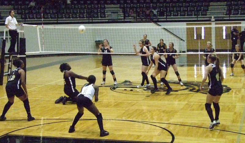 Image: Jimesha gets under — Sophomore, Jimesha Reed, gets low to hit that ball back.