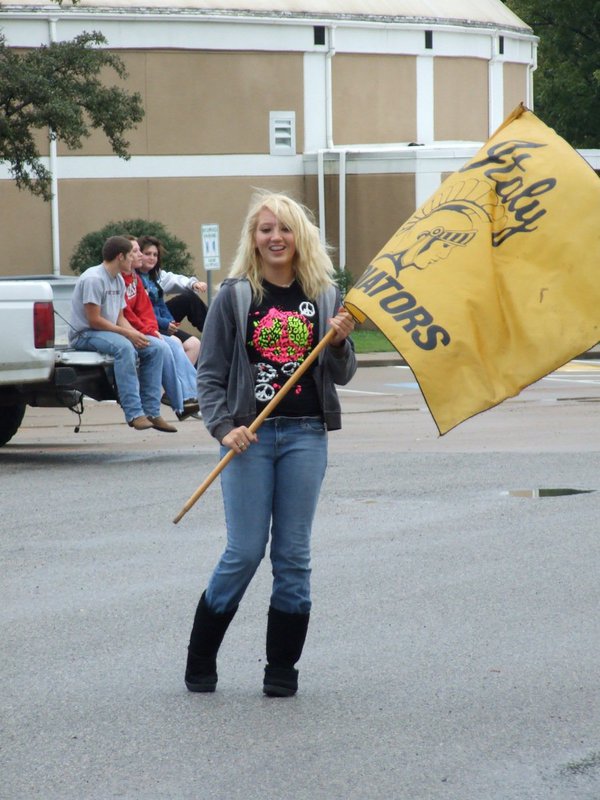 Image: Can’t rain on our parade — Megan Richards held the Italy Gladiator flag to lead the parade in the rain.
