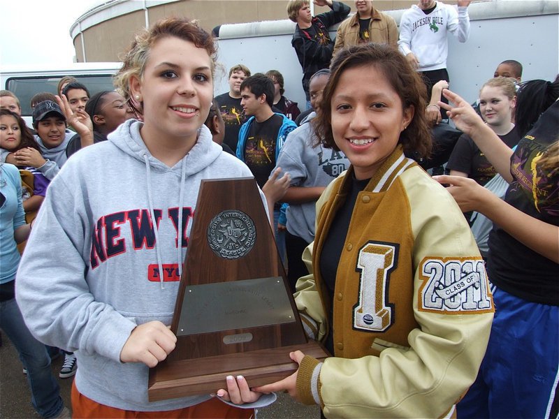 Image: Molly and Jessica — Co-drum majors, Molly Haight and Jessica Hernandez, stand with the trophy.