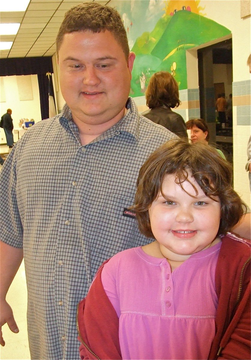 Image: Family event — Virginia Stephens is accompanied by her dad at the PTO dinner and silent auction.