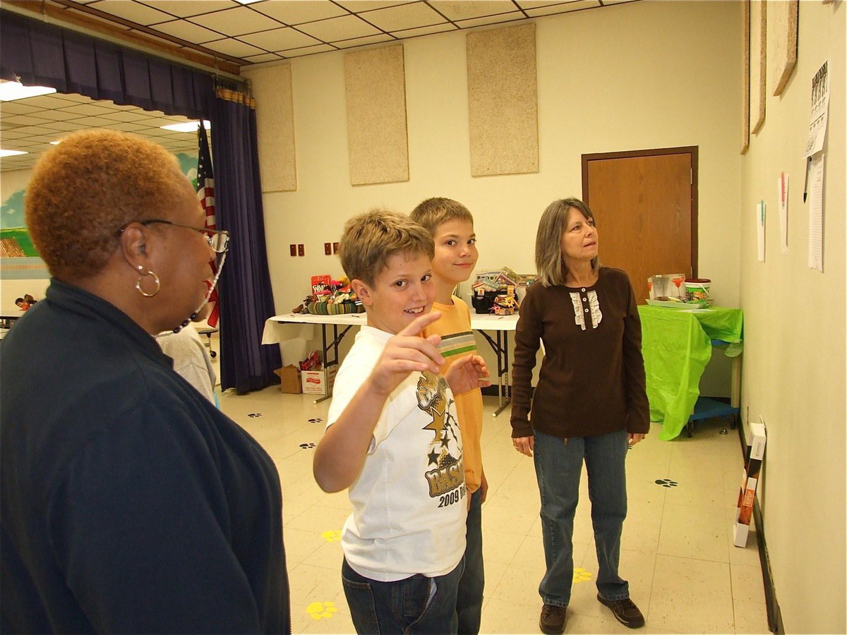 Image: What’s this item? — Mrs. Maevers, on the right, explains the items available for bidding during the silent auction.