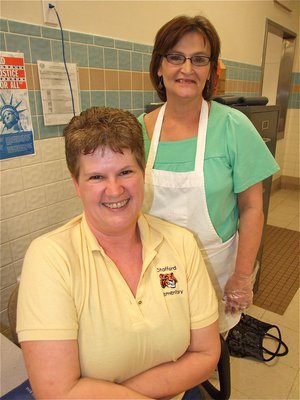 Image: Service with a smile — DeeDee Hamilton and Darlene McBride offer service with a smile during the Stafford Elementary PTO dinner and silent auction.