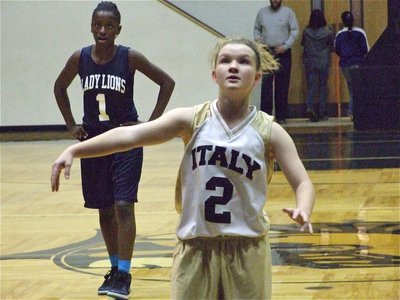 Image: Tara wills it in — Tara Wallis(2) tries to will the ball into the hoop.
