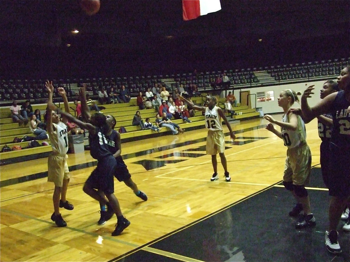 Image: Minton from outside — Alex Minton tries a long shot against the Lady Lions defense.