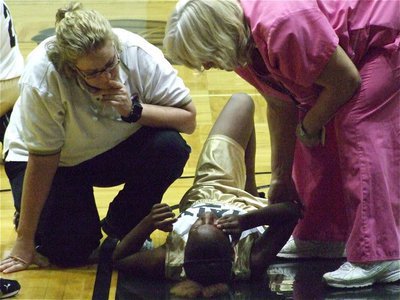 Image: Down and out — Italy’s Kortnei Johnson falls hard and had to leave the game early as concerned Coach, Stacy McDonald, and Italy ISD Nurse, Rita Garza, check on her.