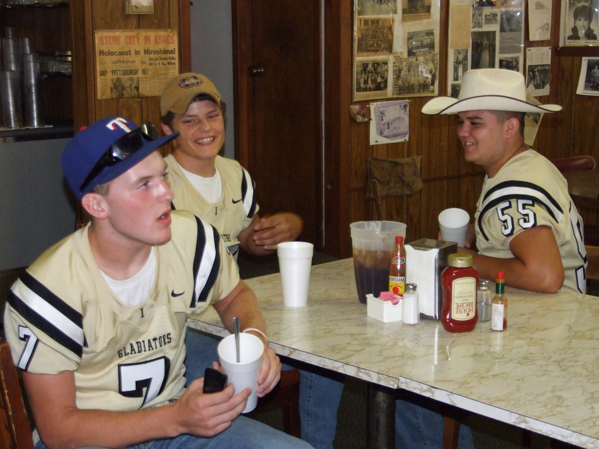 Image: Feeling good — Kyle, Ethan and Ross joke around after their meal.