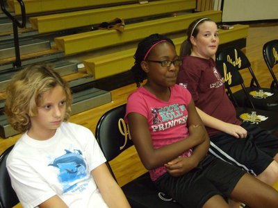 Image: Game faces on — Mackenzie, K’Breona and Reagan take a break during practice.
