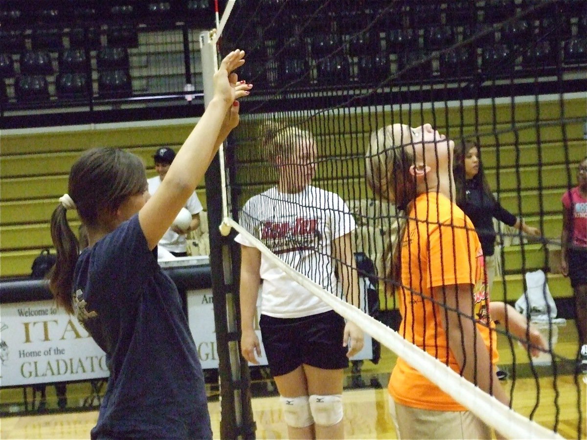 Image: Awaiting the serve — Salcido, Lewis and Washington get set for the serve.