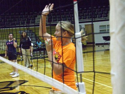 Image: Ready to spike it — Bailey DeBorde and Madison Washington get ready to return volley while coach Tina Richards looks on.