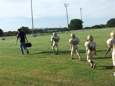 Image: Gladiator ducklings — Coach Gary Wood leads his young Gladiator ducklings into Wildcat stadium. Don’t let their size fool you, the C-Team knocked the quack out of Scurry-Rosser for a 25-0 win.