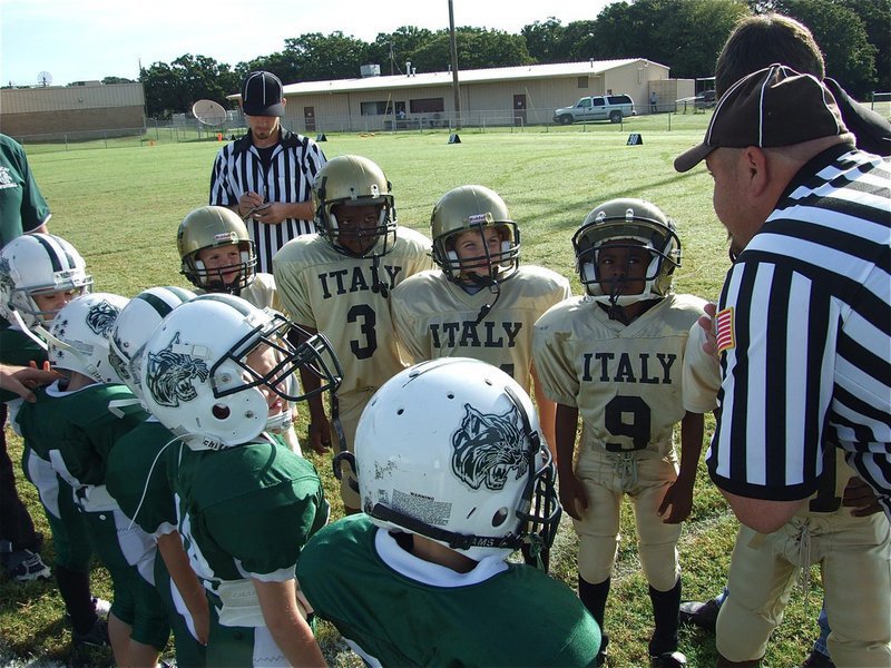 Image: The coin flip — C-Team Captains Bryce Deborde, Ricky Pendleton, Gage Wafer and Tyvon Gates prepare for the ceremonial coin flip.