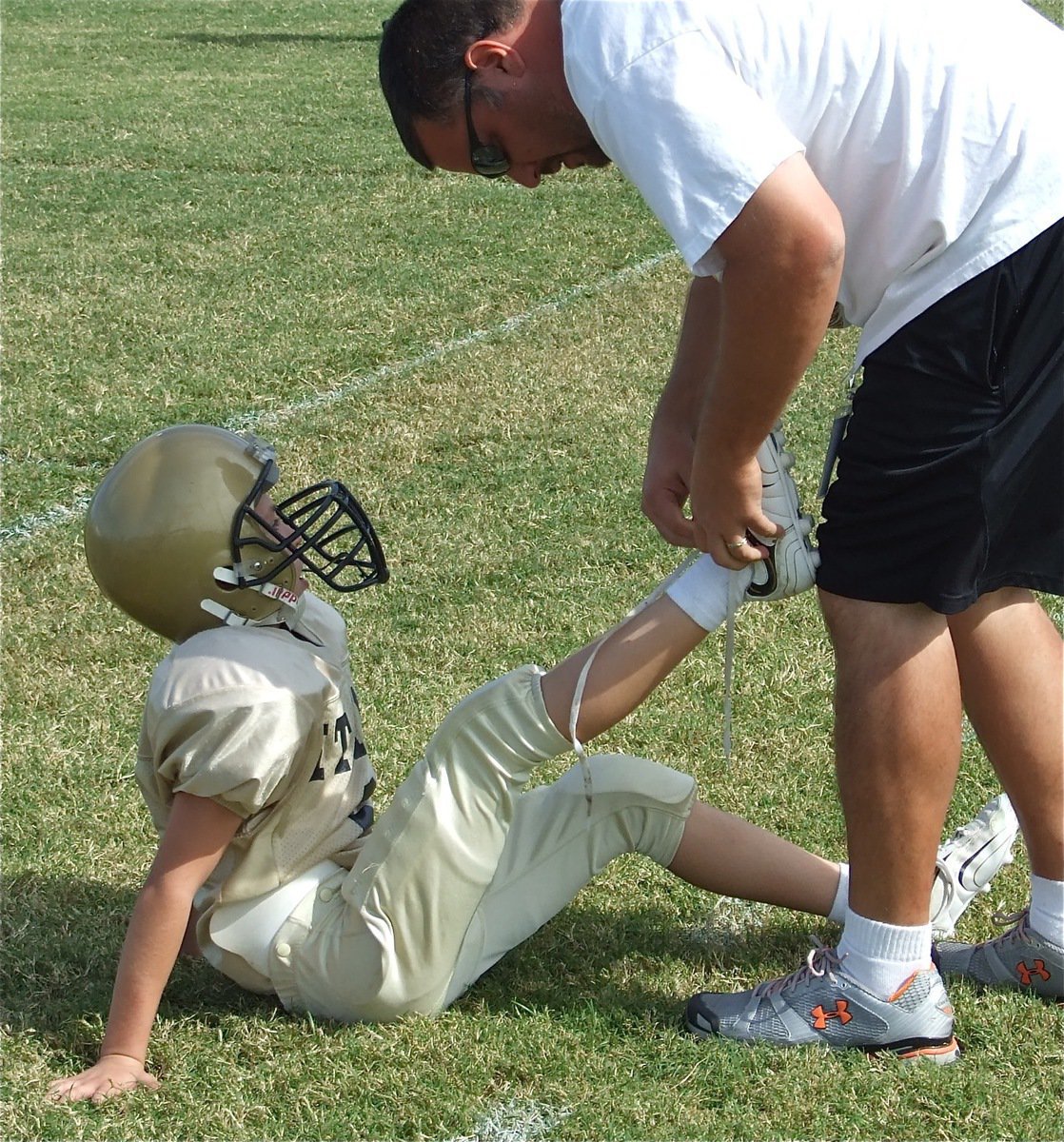 Image: Coach Dad — Ryder “Whiteshoes” Itson gets a helping hand from his dad, and B-Team assistant coach, Aaron Itson.