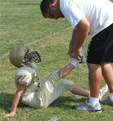 Image: Coach Dad — Ryder “Whiteshoes” Itson gets a helping hand from his dad, and B-Team assistant coach, Aaron Itson.