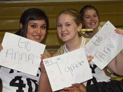 Image: We’re in it together — 8th graders Monserat Figueroa, Jesica Wilkins and Taylor Turner hold up spirit signs in a show of support for the 7th grade girls team.