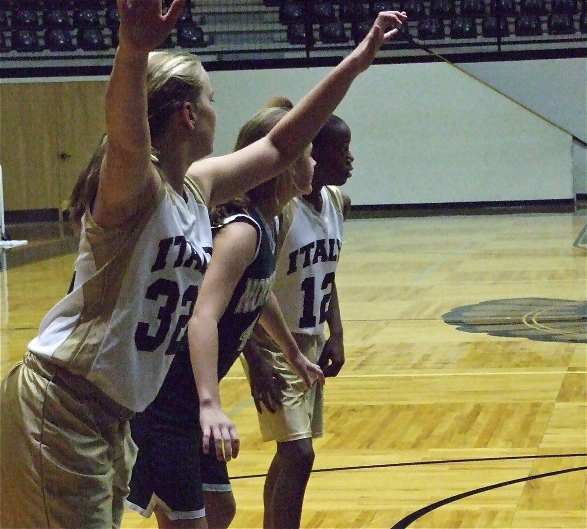 Image: Madison and Kortnei — Italy’s Madison Washington(32) and Kortnei Johnson(12) prepare to rebound an Irving North Hills missed free throw.