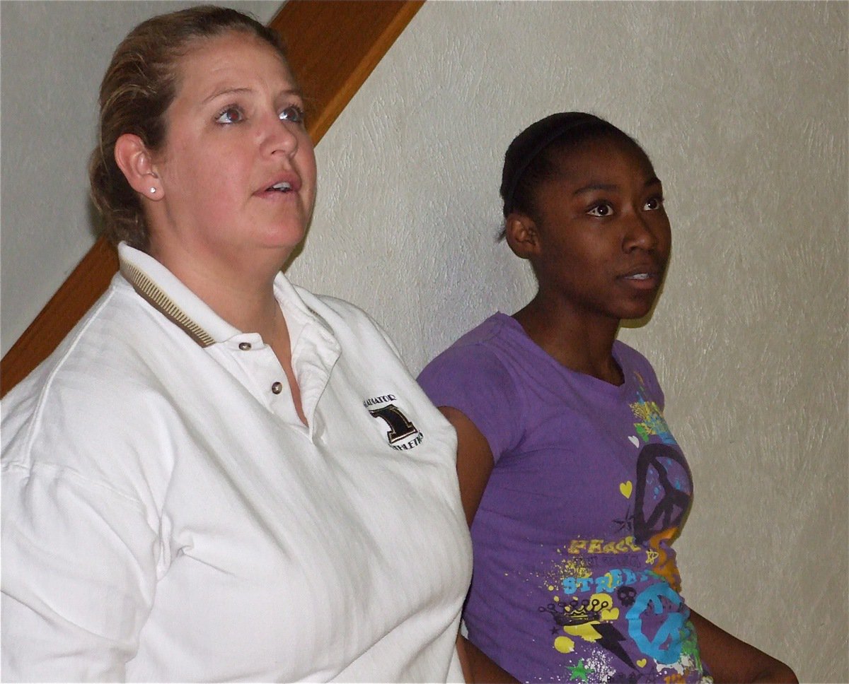 Image: Coach and player — Coach Stacy McDonald and Chante Birdsong watch the 8th grade girls practice layups.