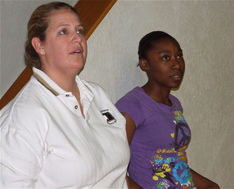 Image: Coach and player — Coach Stacy McDonald and Chante Birdsong watch the 8th grade girls practice layups.