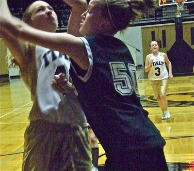Image: Jaclynn goes up strong — Jaclynn Lewis(41) pounds the offensive boards while taking a pounding herself as Reagan Cochran(3) rushes down the floor.