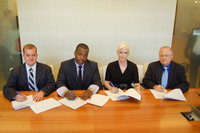 Image: Contract signing in Los Angeles — (L-R) Andrew South, Won-G, Rebecca South and David South