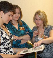 Image: I remember that! - Jennifer Roberts, Pam Mosley and Cheryl Finch-Hiller look through the 1988’89 yearbook. “Look at my hair!”