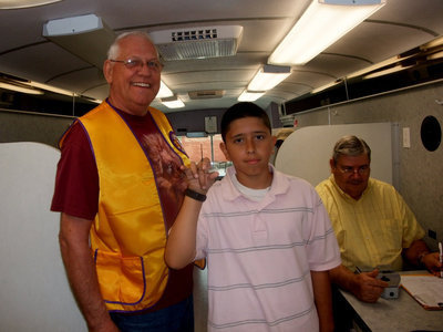 Image: Danny Fletcher and Joseph Sage — Joseph said, “I am getting my eyes checked and I am hoping I don’t have to wear glasses.” Danny Fletcher, “I am assisting on the bus. I am with the Lions Club in Dallas.”