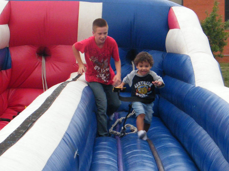 Image: How Fast Can You Run? — Dylynn and Aiden having a blast on the bungee pull.