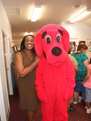 Image: Felicia Burkhalter and Clifford — Felicia Burkhalter was busy helping with the book fair but stopped long enough to get her picture taken with Clifford.