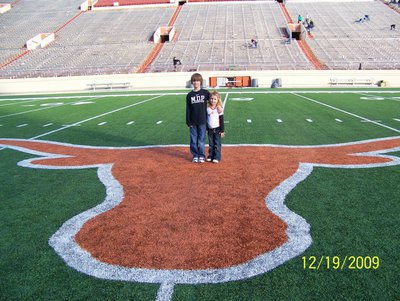 Image: Grant and Skyler — Grant Seay and Skyler Seay stand on the Texas Longhorn logo at midfield of Joe Jamail Field after the battle between the Aledo Bearcats and the Brenham Cubs.