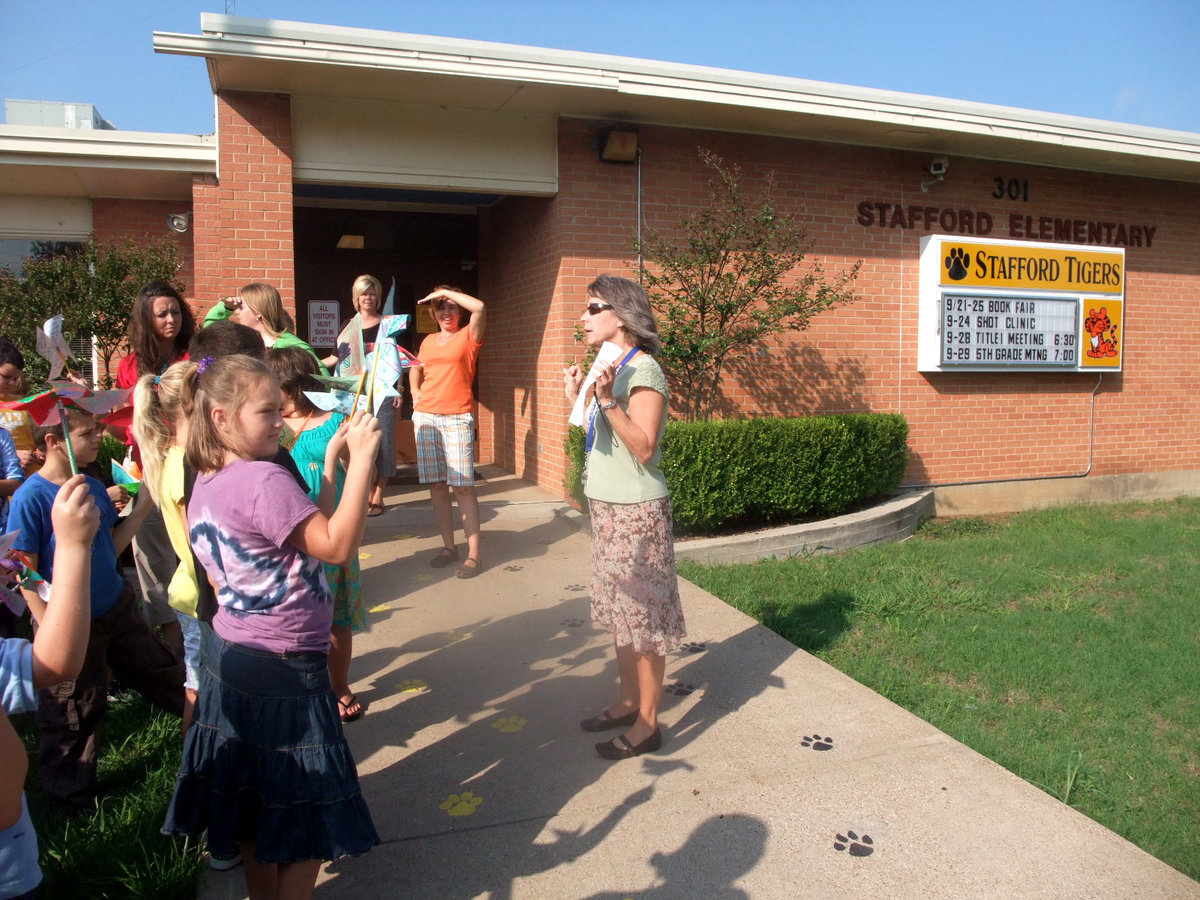 Image: Carolyn Maevers and Students — Carolyn Maevers told the students that today everyone around the world would be spinning pinwheels.