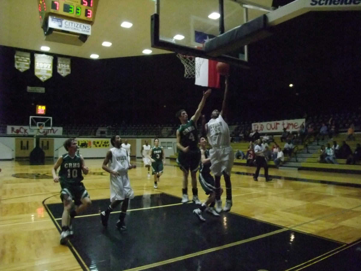 Image: Anderson Again — You can’t stop it. You can think about stopping it…but you can’t do it. Jasenio Anderson #11, bothered by an ankle sprain gets the green light to play against Crossroads.