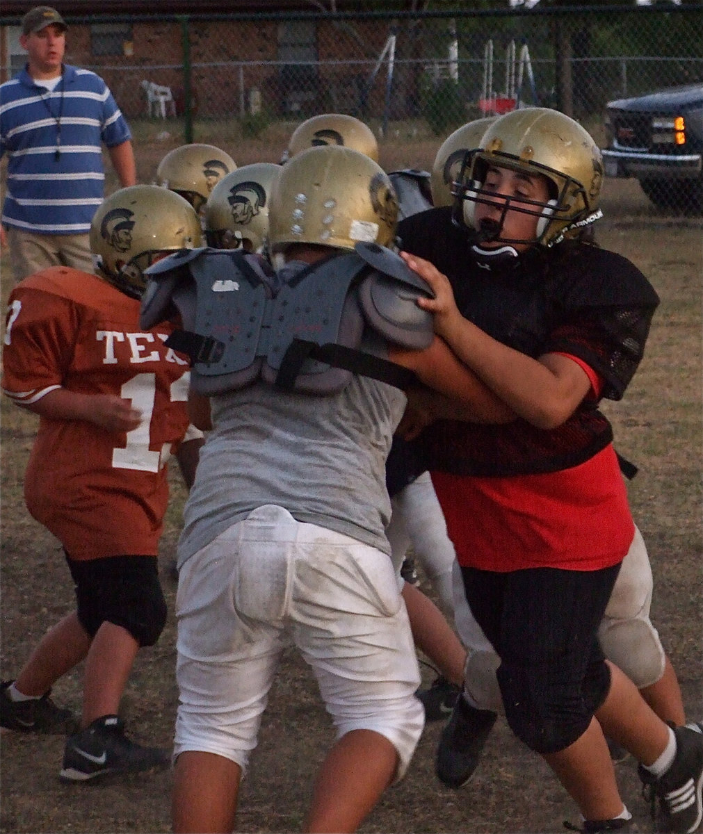 Image: Trench Dawgs — These lunch pail types work in the IYAA Football factory. It’s a living.