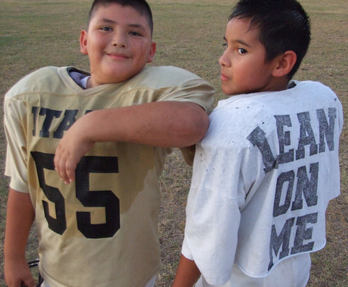 Image: Lean on me… — Teammates are there for each other.