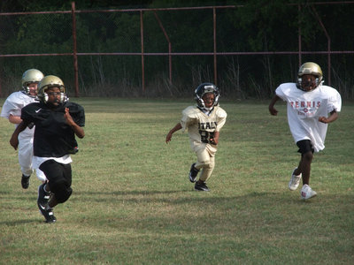 Image: Football fast — The Bantam players learn how to run with footaball pads on.