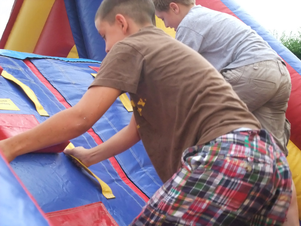 Image: Brothers race — Brothers Gary and J.T. Escamilla try to reach the slide first.