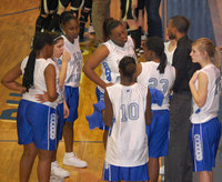 Image: Huddle — Coach Larry Williamson rallies the girls for the last few seconds of the game.