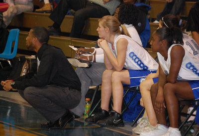 Image: Courtside — Coach Williamson watching the game along with other team members.