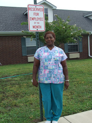 Image: Reserved Parking — Mary is standing in front of her reserved parking spot which she will have for one month.