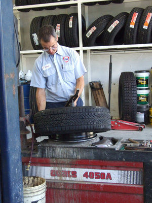 Image: Steve Working Hard — Varner Fina offers a full service tire shop.