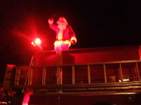 Image: Santa Claus Waves to All — Santa Claus came to town by way of the Milford Fire Engine.