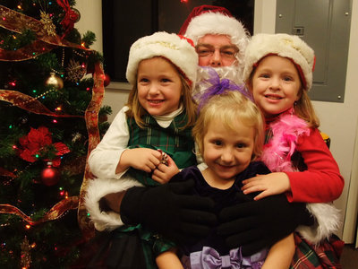 Image: Can you find Santa? — Lucky Santa is surrounded with three little beauties.