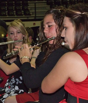 Image: Flute cuties — Sierra Harris, Nikki Brashear and Molly Haight play their flutes.