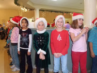 Image: Don Your Gay Apparel — First and Second graders, dressed in their Christmas clothes, entertaining the crowd at Trinity Mission.