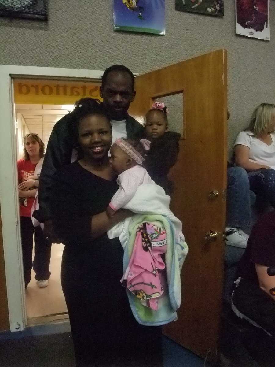 Image: Kevin and Christi Fleming — The Flemings and their two girls came to the awards assembly to see their brother receive an award.