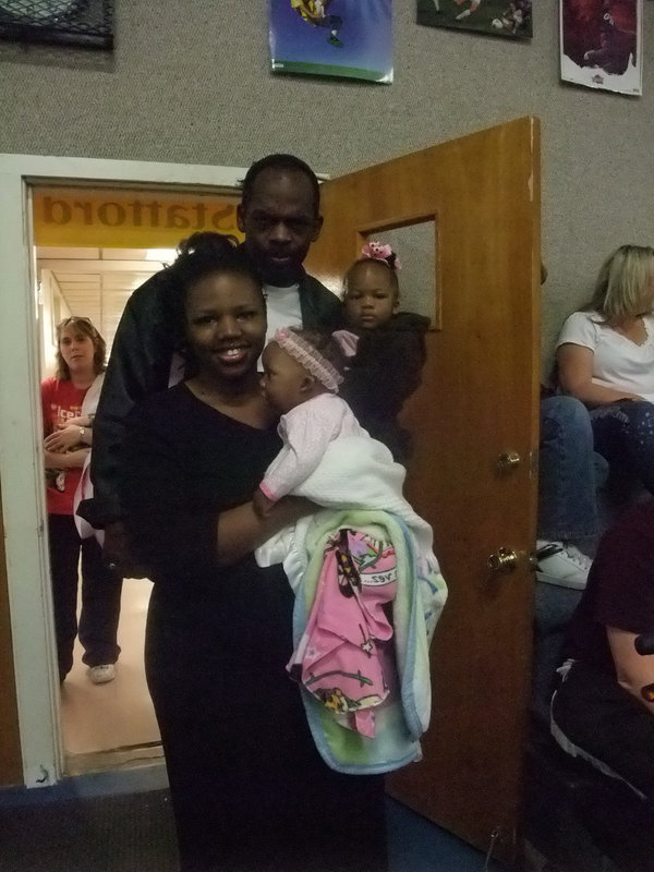 Image: Kevin and Christi Fleming — The Flemings and their two girls came to the awards assembly to see their brother receive an award.