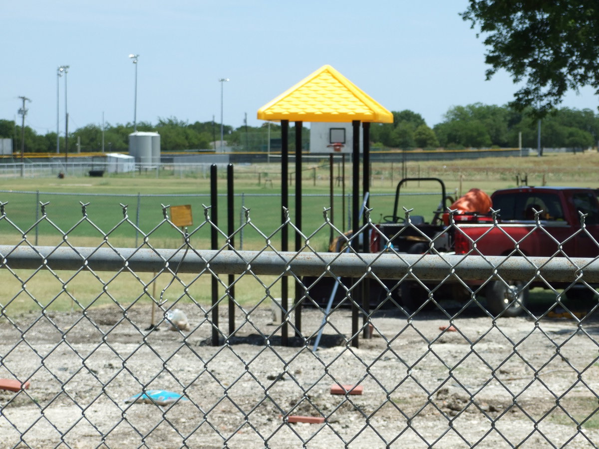 Image: Cemented Poles — The poles were being cemented in today at the park.